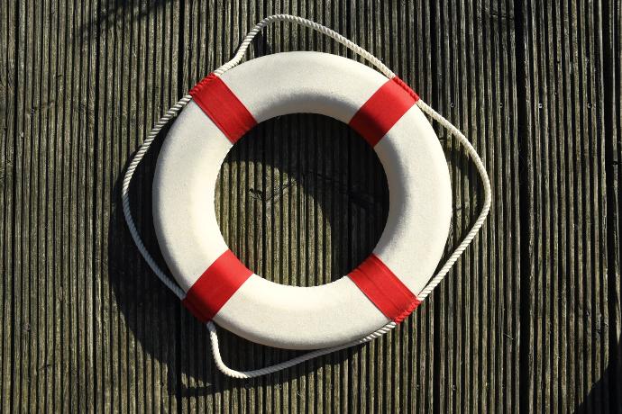 Photo of a white and red lifebuoy.